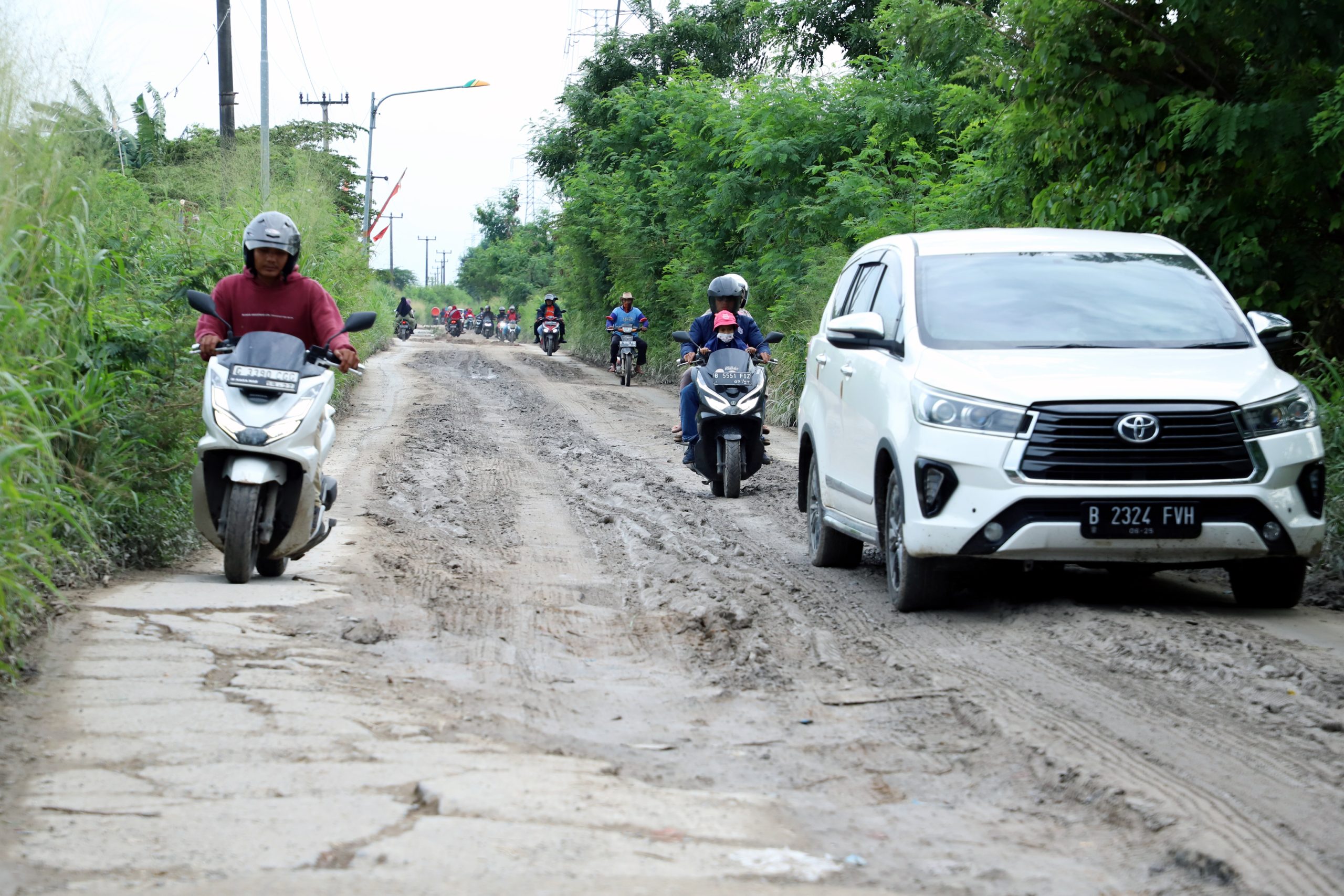 Potret pengendara roda dua dan empat saat melewati ruas Jalan Cikarang Bekasi Laut (CBL) yang akan diperbaiki oleh Pemkab Bekasi secara bertahap.