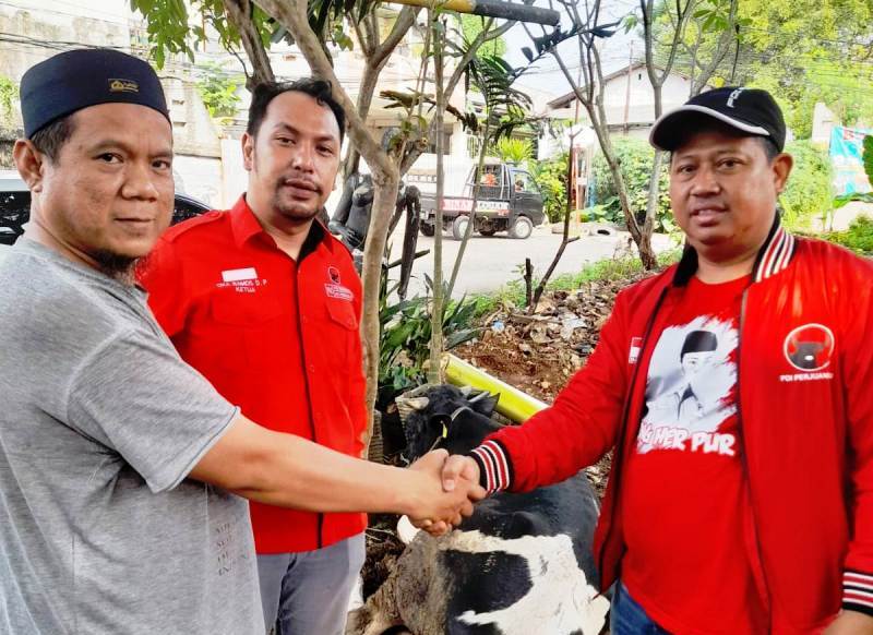 Heri Purnomo (kanan) saat menyerahkan sapi kurban.